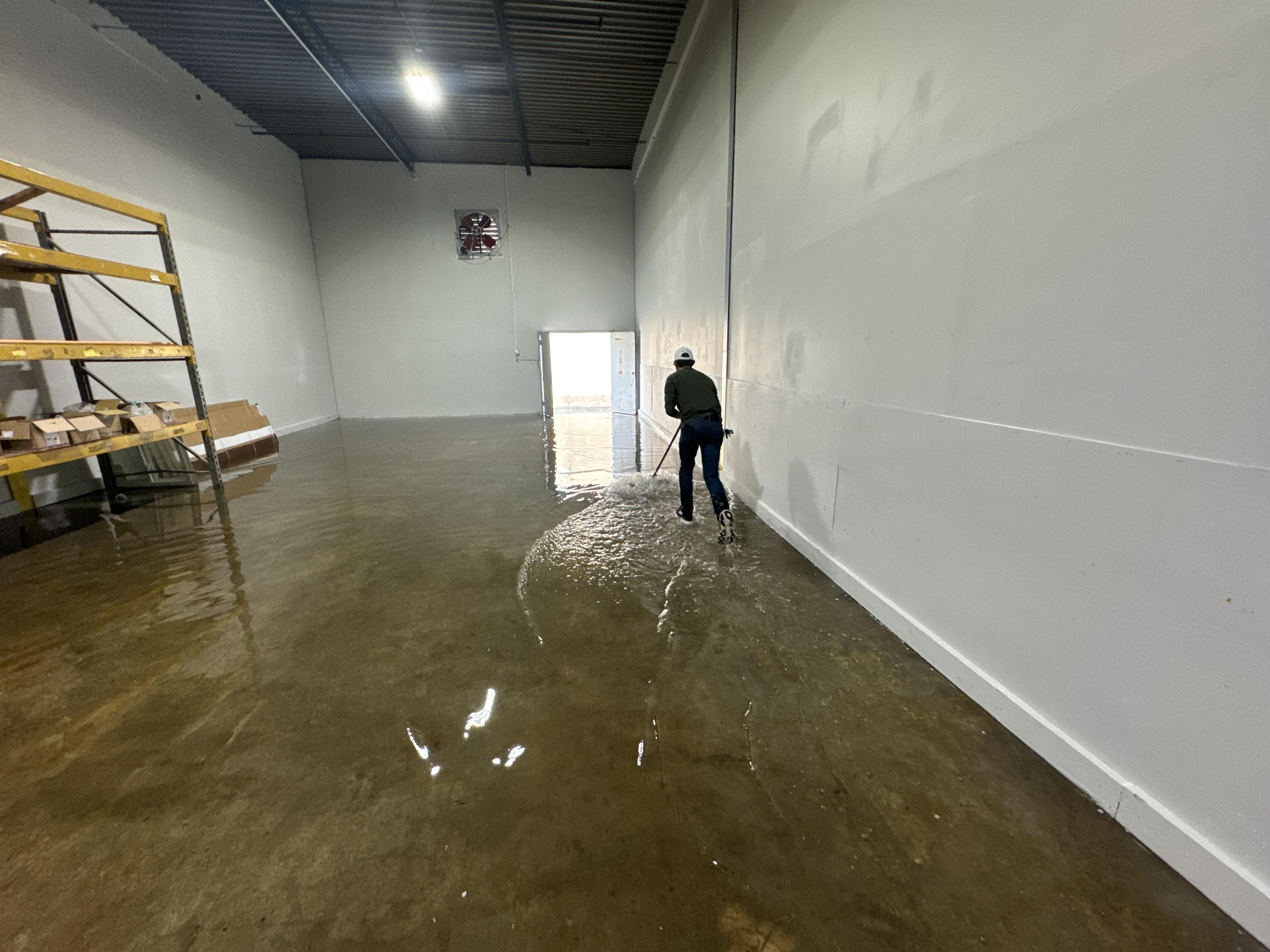 IRS crew member extracting standing water from a Austin commercial building