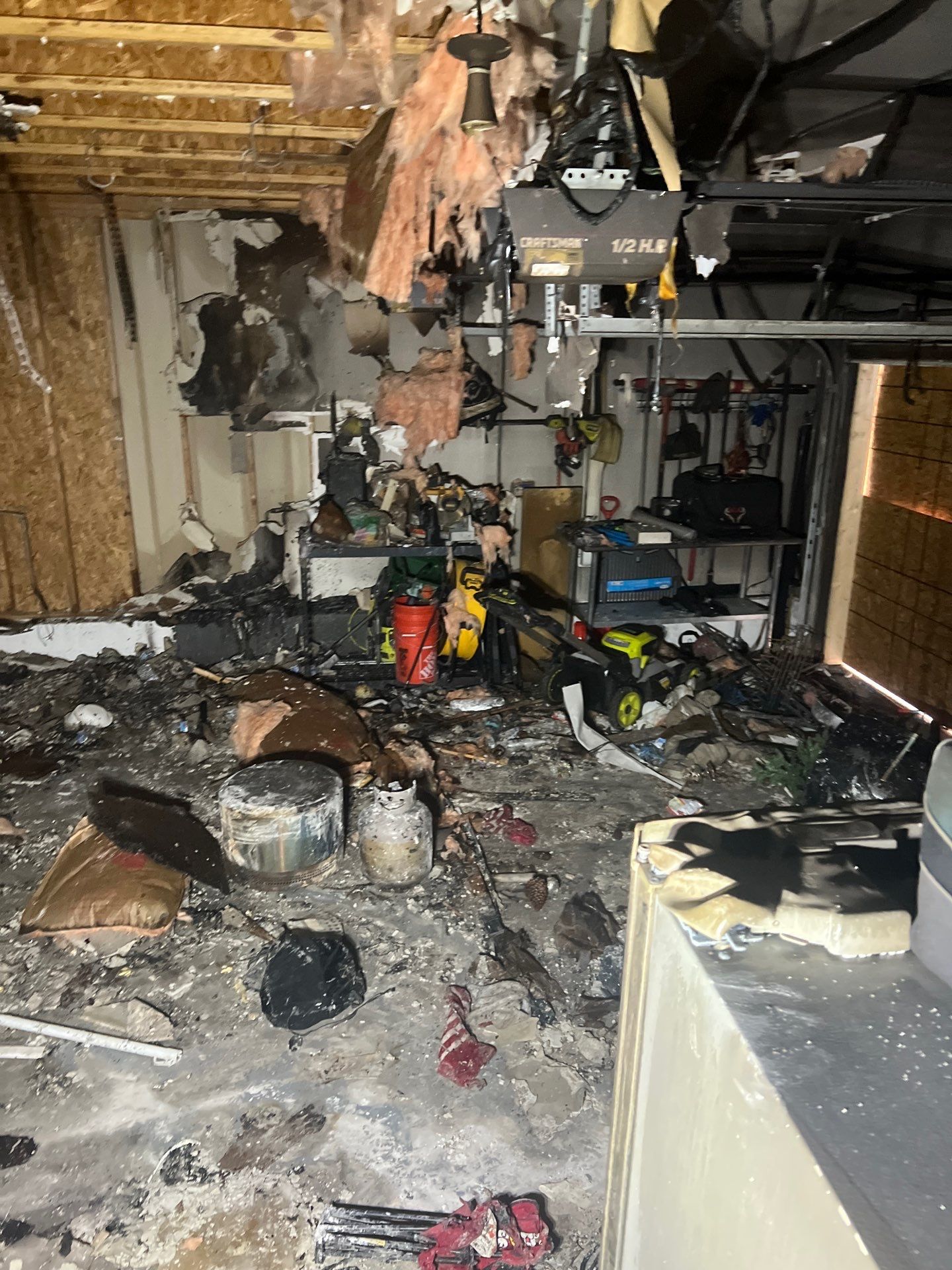 Extensive fire damage inside a Austin garage cleared by IRS crew